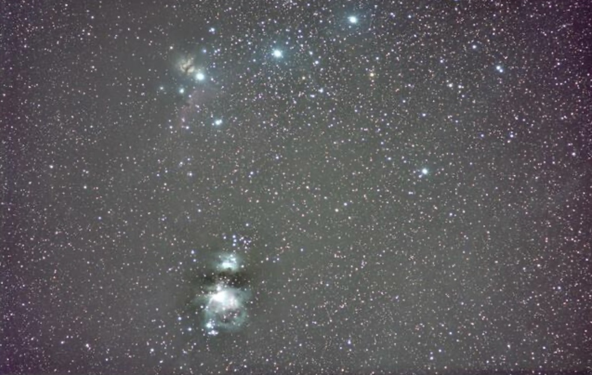 A wide starfield showing the Orion Nebula and surrounding star clusters